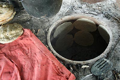Closeup of the glazed oven and the totopes cooking.